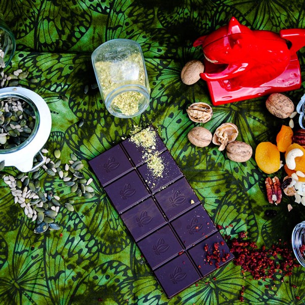 composition of red nut cracker squirrel, dark chocolate and green background