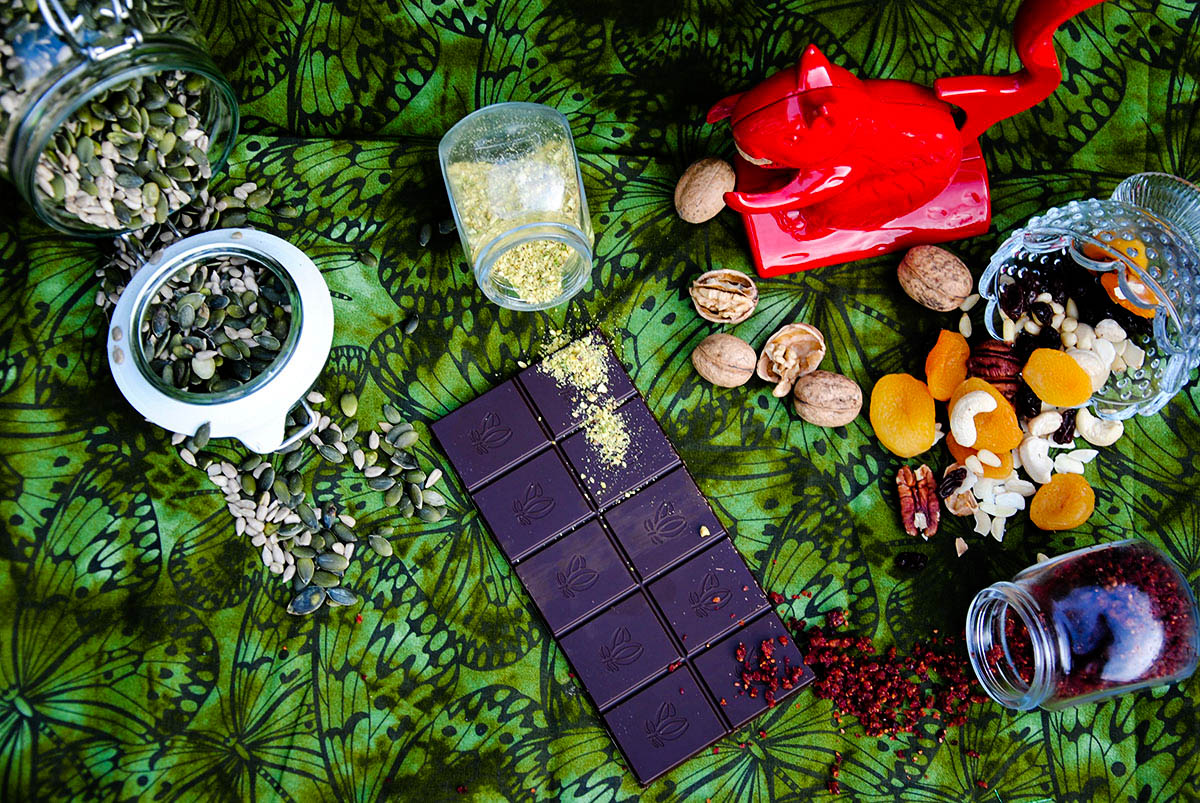 composition of red nut cracker squirrel, dark chocolate and green background