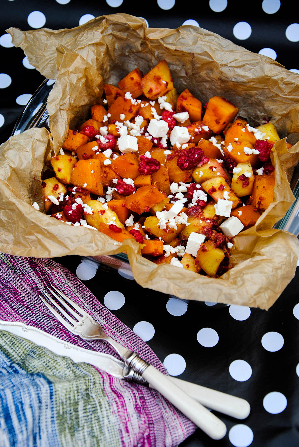 baked butternut squash and cinnamon pumpkin, honey and raspberries with feta in a baking pan