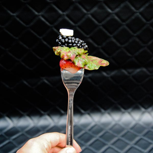 blackberry, feta cheese, spinach and strawberry on a fork