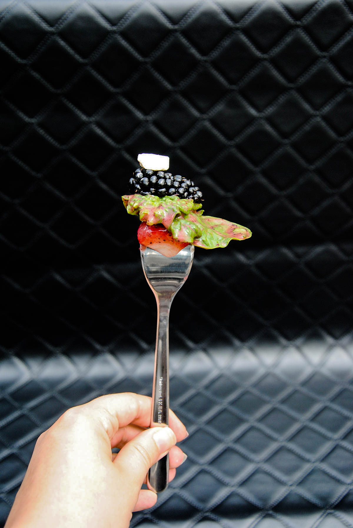 blackberry, feta cheese, spinach and strawberry on a fork