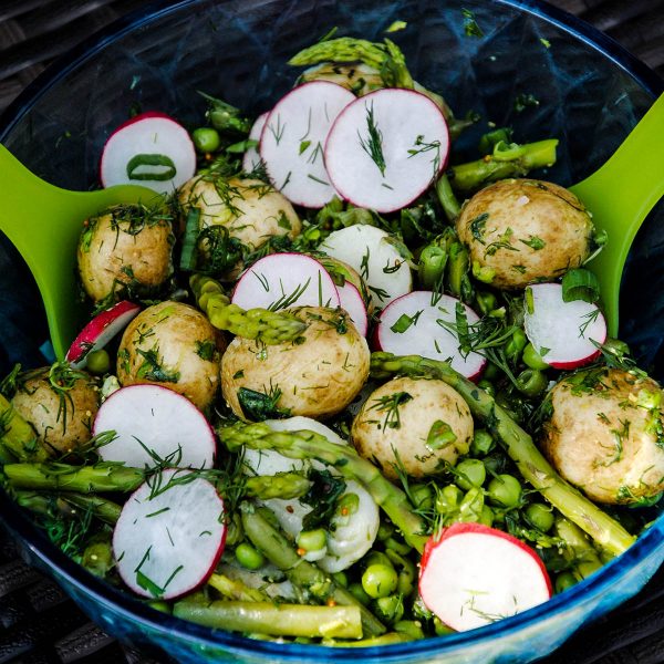 Potato salad with radish, asparagus, dill and other greens