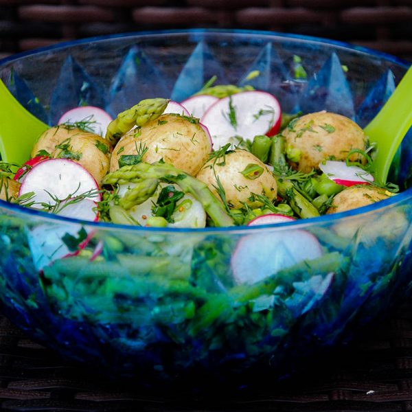 Potato Salad in transparent blue glass bowl