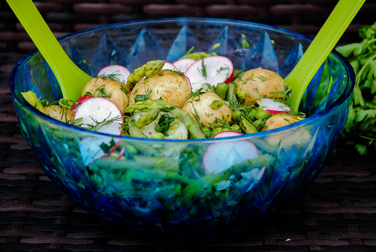Potato Salad in transparent blue glass bowl