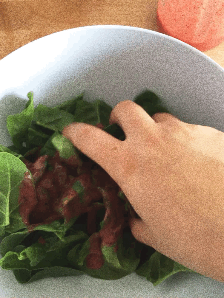 Mixing spinach with strawberry sauce