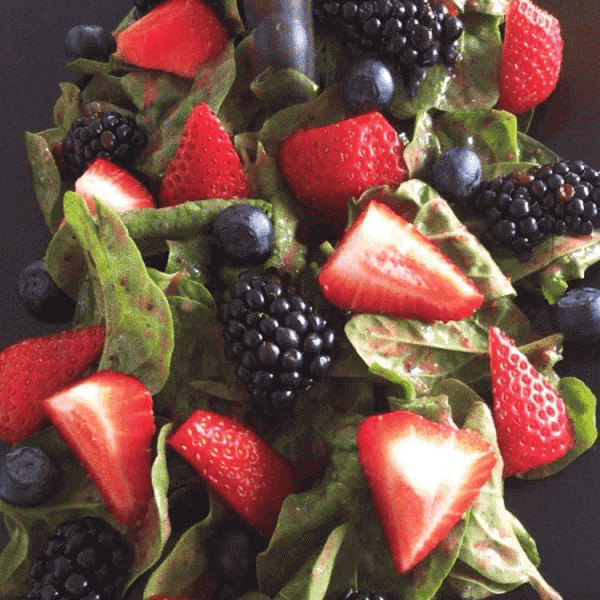 Dropping blueberry on strawberry sauce salad