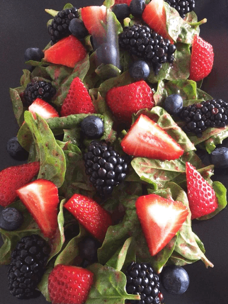 Dropping blueberry on strawberry sauce salad