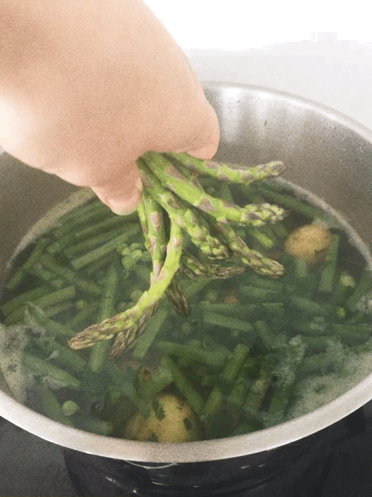 Dipping asparagus in boiling water